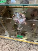 Full view of agate slab on metal stand within display cabinet