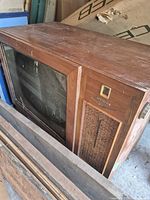 Three-quarter view of wood cabinet and screen