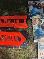 Front of both signs showing red arrows and text