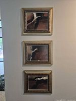 full view of three paintings hung vertically