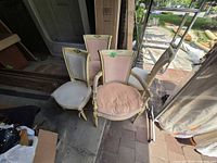Stacked view of four French Louis style upholstered chairs showing overall design and colors