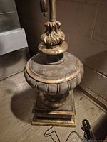 full view of lamp base, square plinth, urn body showing worn gilded finish