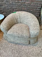 Front view of beige bouclé tub chair