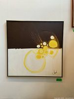 Full front view of framed square painting hung on wall