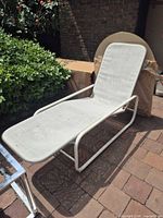 Full view of chaise lounge showing frame, sling and overall style