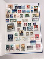 Page of Canadian and other international stamps in album