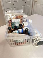 Basket with clays, oils, botanicals, immersion blender cord visible