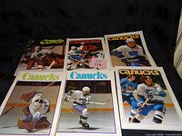 Six 1970s Vancouver Canucks magazines laid out front covers visible