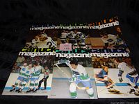 Front view of six Vancouver Canucks magazines laid out, showing cover designs