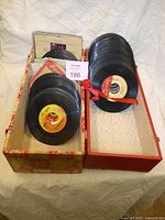 Two boxes holding stacked 7" singles, about 150 total