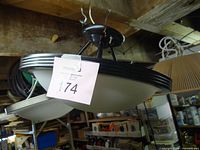 assembled view of ceiling light hanging, showing black rim and frosted glass