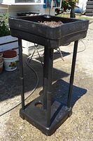 Full view of assembled black plastic upside-down tomato planter