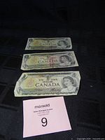 Obverse of three 1973 Canadian $1 notes with Queen Elizabeth II portrait