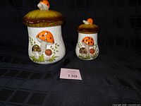 Both ceramic mushroom canisters with lids
