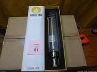 Boxed Solis Tek 1000W HPS lamp with sleeve slid open showing bulb