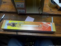 Front view of boxed HiLUX GRO bulb showing branding and 1000 W rating