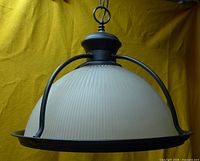 Front view of pendant showing glass dome and metal frame
