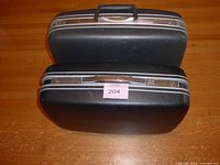 Two Samsonite hard-shell suitcases closed, showing exteriors and handles