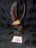 Front view of carved wood eagle showing overall form and color