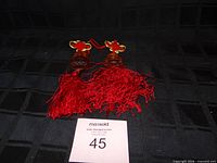 Both pendants side by side showing overall size and tassel condition