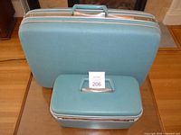 Front view of both turquoise Samsonite cases
