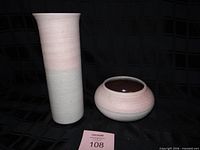Tall cylindrical vase and round bowl together showing size and color gradient