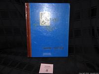 Front cover of blue stamp album with brown spine