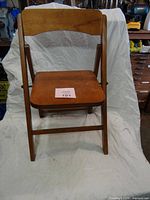 Front view of child-size wooden folding chair unfolded