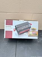 Front of sealed Brookstone Grill Tumbler retail box