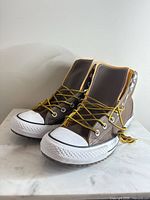 Three-quarter front view of both shoes showing uppers, laces, toe caps, and outsoles