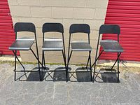 Front view of four matching foldable bar stools lined up