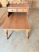 Front view of the Mersman end table showing top, lower shelf, drawer, turned legs and overall wear