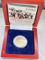 Coin in capsule inside presentation box with certificate card