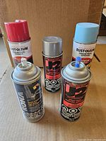 All five spray paint cans front view