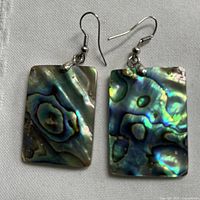 Front view of both abalone shell earrings showing iridescent surfaces