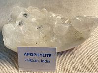 Oblique front view of entire apophyllite cluster with identification card