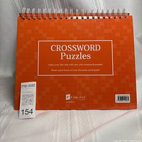 Front cover of orange spiral crossword puzzle book