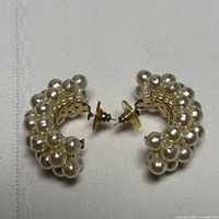 pair of gold-tone half-hoop earrings covered in faux pearls