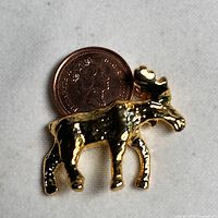 Front view of gold-tone moose with 1999 Canadian penny inset