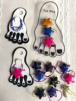 Group of toe rings including three on display cards and ten loose