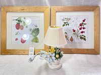 Full lot view showing both framed prints and lamp
