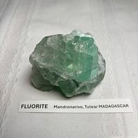 Front view of green fluorite cluster with locality label