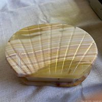 Top view of oval onyx jewelry box showing natural banding and polished surface