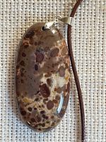 Front of oval leopard skin jasper pendant on cord