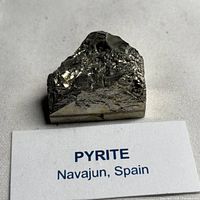Front view of the pyrite crystal cluster with locality card