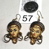Pair of maiden face hoop earrings on scale tag