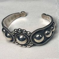 Full view of sterling silver cuff bangle showing bead and rope design