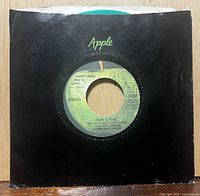 Front of black Apple sleeve showing center label of green vinyl 45 rpm