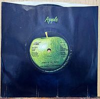 Front of 7-inch record in black Apple sleeve showing centre label