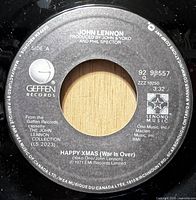 Side A label showing catalog number 92 98557 and song title Happy Xmas (War Is Over)